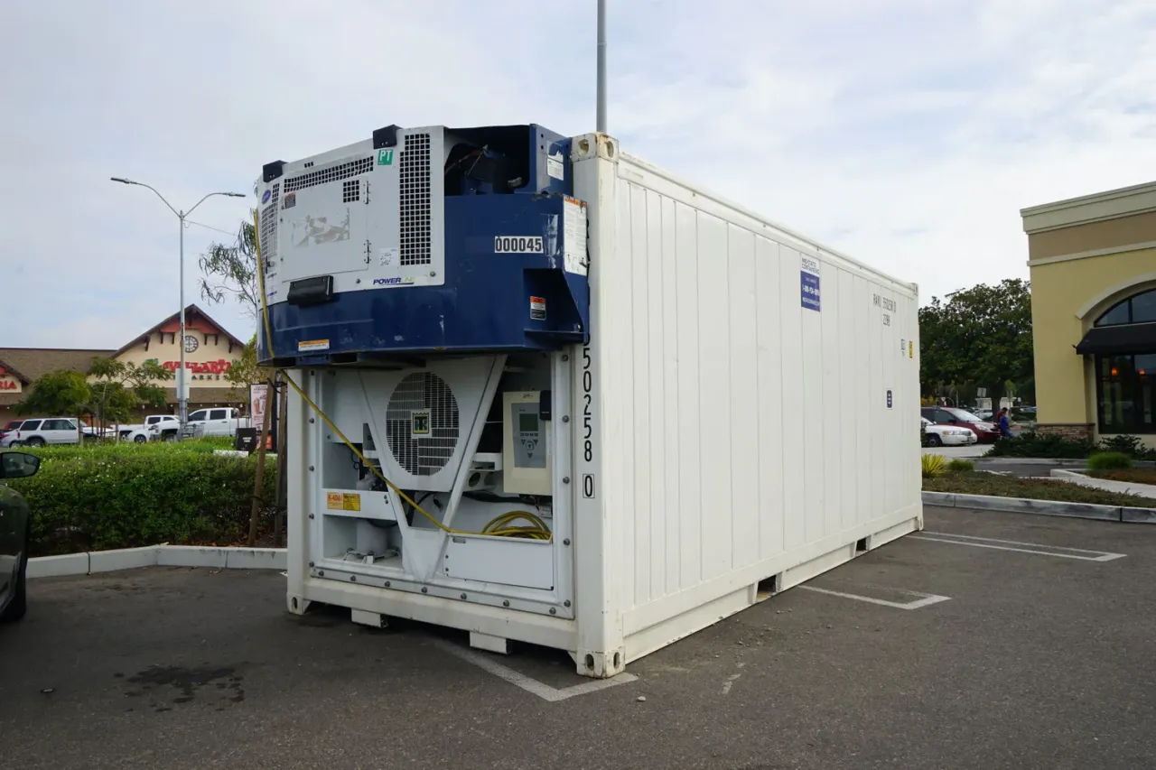 Clip-on generator set mounted to the end wall of a white refrigerated shipping container