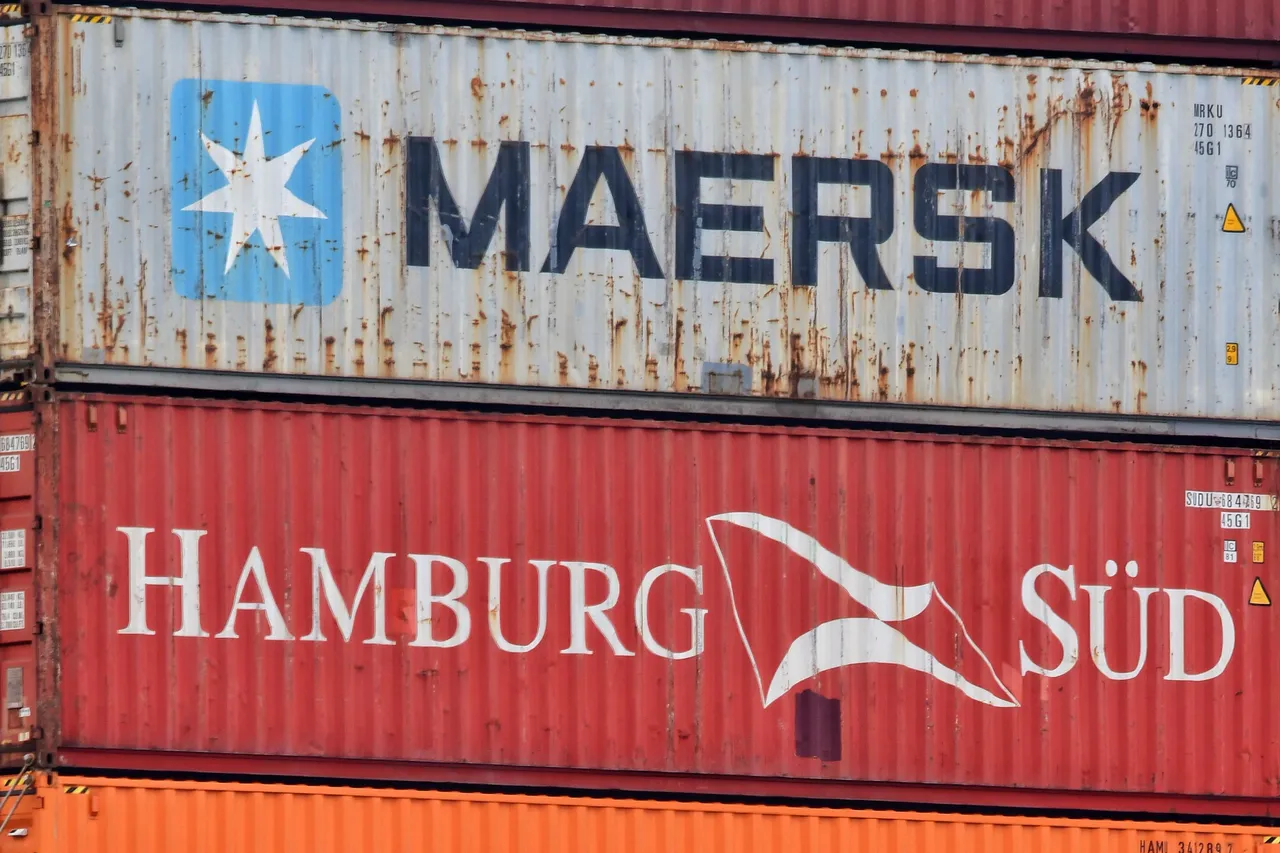 Close-up of two stacked shipping containers showing weathering and surface rust